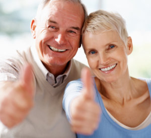 Success - Portrait of a older couple showing thumbs up